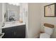 Stylish bathroom with a dark vanity, modern fixtures, and decorative wall art at 1107 Trappers Trail Loop, Davenport, FL 33896