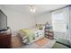 Bright bedroom featuring a ceiling fan, carpeted floor, and a window with white curtains at 1107 Trappers Trail Loop, Davenport, FL 33896