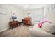 Bedroom with a sofa, desk, computer and decor; a cozy and functional space at 1107 Trappers Trail Loop, Davenport, FL 33896