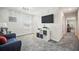 Bright bonus room with gray carpet, large television and decorative storage shelves at 1107 Trappers Trail Loop, Davenport, FL 33896