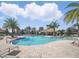 Beautiful community pool with plenty of seating, landscaping and a tiki bar at 1107 Trappers Trail Loop, Davenport, FL 33896