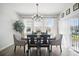 Bright dining area featuring a chandelier, large windows, and stylish decor at 1107 Trappers Trail Loop, Davenport, FL 33896