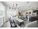 Elegant dining room with a large table and chairs, connecting to the living room and kitchen at 1107 Trappers Trail Loop, Davenport, FL 33896