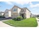 Exterior view of a two-story home with a brick paved driveway and landscaped front yard at 1107 Trappers Trail Loop, Davenport, FL 33896