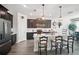 Kitchen with stainless steel appliances, a breakfast bar, and dark cabinetry at 1107 Trappers Trail Loop, Davenport, FL 33896
