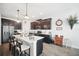 Modern kitchen with dark cabinets, white countertops, and a breakfast bar at 1107 Trappers Trail Loop, Davenport, FL 33896