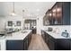 Spacious kitchen with a large island, dark cabinetry, and modern appliances at 1107 Trappers Trail Loop, Davenport, FL 33896