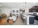 Open floor plan showcasing the kitchen and living room with modern furnishings at 1107 Trappers Trail Loop, Davenport, FL 33896