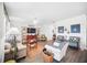 Inviting living room featuring wood floors, comfortable seating, and a ceiling fan at 1107 Trappers Trail Loop, Davenport, FL 33896