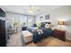 Comfortable main bedroom featuring a ceiling fan, carpeted floor, and a decorative bench at 1107 Trappers Trail Loop, Davenport, FL 33896