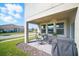 Covered patio with outdoor seating, perfect for entertaining with lovely landscape view at 1107 Trappers Trail Loop, Davenport, FL 33896