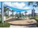 Community playground featuring swings, slides, and a shade structure over the play area at 1107 Trappers Trail Loop, Davenport, FL 33896