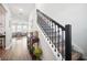 Interior view showcasing a carpeted staircase with dark wood railing and tiled flooring at 1107 Trappers Trail Loop, Davenport, FL 33896