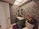 Bathroom showcasing a single sink vanity, decorative tile mirror, toilet, and fixtures at 133 La Casa # 133, Lake Wales, FL 33898