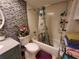 Bathroom with a shower-tub combo, decorative tile, toilet, sink, and decorative accents at 133 La Casa # 133, Lake Wales, FL 33898