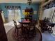 Cozy dining area with a round table, floral arrangements, and natural light at 133 La Casa # 133, Lake Wales, FL 33898
