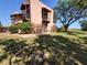 Attractive condo featuring multiple balconies and mature landscaping, with a lush lawn at 133 La Casa # 133, Lake Wales, FL 33898