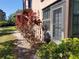 The exterior features attractive landscaping and a screened door, adding curb appeal to the property at 133 La Casa # 133, Lake Wales, FL 33898