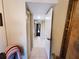 Inviting hallway with tile flooring and neutral paint, leading to other rooms in the home at 133 La Casa # 133, Lake Wales, FL 33898