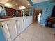 Charming kitchen features white cabinets and tiled flooring, offering both style and easy maintenance at 133 La Casa # 133, Lake Wales, FL 33898