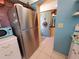 Stainless steel refrigerator in the kitchen complements the blue and white decor for a modern feel at 133 La Casa # 133, Lake Wales, FL 33898