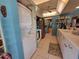 Functional kitchen area with stacked laundry machines for added convenience, and bright cabinets at 133 La Casa # 133, Lake Wales, FL 33898