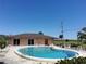 Inviting community pool with pristine clear water, lounge chairs, and adjacent clubhouse for leisure at 133 La Casa # 133, Lake Wales, FL 33898