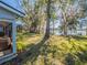 Backyard with mature trees and lake frontage; the perfect setting for relaxation and recreation at 1444 Pelican Bay Trl, Winter Park, FL 32792