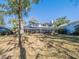 Spacious backyard featuring a screened porch and lush landscaping providing an inviting outdoor space at 1444 Pelican Bay Trl, Winter Park, FL 32792