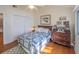 Cozy bedroom featuring hardwood floors, closet, and a comfortable bed with a quilt at 1444 Pelican Bay Trl, Winter Park, FL 32792