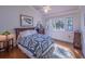Charming bedroom with hardwood floors, natural light, and cozy decor at 1444 Pelican Bay Trl, Winter Park, FL 32792