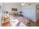 Bright bedroom featuring hardwood floors, ceiling fan, and a comfortable bed with a decorative blanket at 1444 Pelican Bay Trl, Winter Park, FL 32792