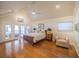 Bright bedroom featuring wood floors, a ceiling fan, and French doors leading to an outdoor area at 1444 Pelican Bay Trl, Winter Park, FL 32792