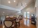 Open dining area with hardwood floors, vaulted ceilings, and adjacent balcony access at 1444 Pelican Bay Trl, Winter Park, FL 32792