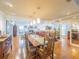 Open dining room with pendant lights, a long table, and access to the main living area at 1444 Pelican Bay Trl, Winter Park, FL 32792