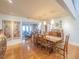 Elegant dining room with wood table, pendant lighting, and a view into the connected living area at 1444 Pelican Bay Trl, Winter Park, FL 32792