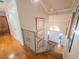 Inviting entryway with hardwood floors, staircase with metal railing, and a view of the front door at 1444 Pelican Bay Trl, Winter Park, FL 32792