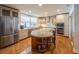 Open kitchen features stainless appliances, custom cabinets, granite counters and a large island with seating at 1444 Pelican Bay Trl, Winter Park, FL 32792