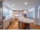 Open kitchen features stainless appliances, custom cabinets, granite counters, large island, and wine fridge at 1444 Pelican Bay Trl, Winter Park, FL 32792