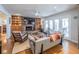 Inviting living room with a fireplace, built-in shelves, and a view to the outside deck at 1444 Pelican Bay Trl, Winter Park, FL 32792