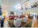 Bright and airy living room featuring a vaulted ceiling, fireplace, and views of the upper level balcony at 1444 Pelican Bay Trl, Winter Park, FL 32792