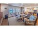 Comfortable living room with water view features a sofa, chairs, and an open connection to the kitchen at 1444 Pelican Bay Trl, Winter Park, FL 32792