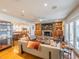 Cozy living room connected to the dining area featuring a fireplace and built-in shelving at 1444 Pelican Bay Trl, Winter Park, FL 32792