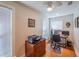 Well lit office features hardwood floors, windows and a ceiling fan at 1444 Pelican Bay Trl, Winter Park, FL 32792