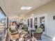 Spacious covered patio includes a skylight, ceiling fans, outdoor seating, and lake views at 1444 Pelican Bay Trl, Winter Park, FL 32792
