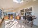 Open-air patio with skylight, ceiling fan, kitchen area, and bar overlooking the lake at 1444 Pelican Bay Trl, Winter Park, FL 32792