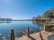 Scenic waterfront view with lily pads and a charming dock featuring partial outdoor seating at 1444 Pelican Bay Trl, Winter Park, FL 32792