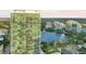 Gorgeous aerial view of high-rise residential building overlooking a lake and featuring serene, green surroundings at 150 E Robinson St # 219, Orlando, FL 32801