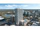 Stunning aerial view showcasing the high-rise building, surrounding cityscape, and picturesque lake at 150 E Robinson St # 219, Orlando, FL 32801