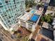 A unique perspective from above, showing a building's rooftop pool and basketball court, framed by city views at 150 E Robinson St # 219, Orlando, FL 32801